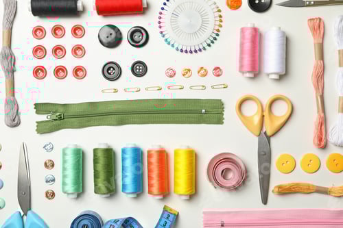 Preview: Flat lay with sewing supplies on white background