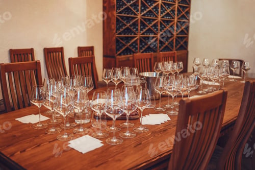 Preview: Glass goblets placed in rows on table during wine tasting procedure in restaurant