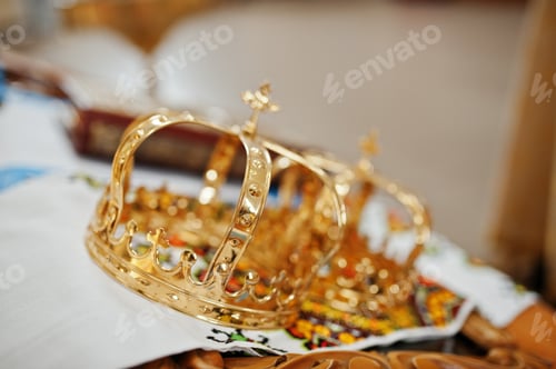 Preview: Golden wedding crowns at church ceremony.