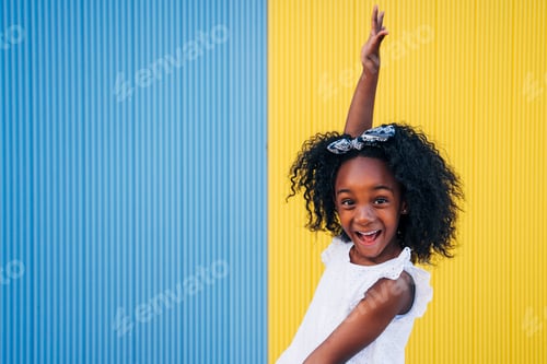 Preview: Cute mixed race girl having fun at street. Child innocence concept.