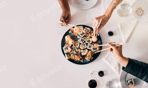 Preview: Fresh from the sea. Shot of a group of friends enjoying sushi.