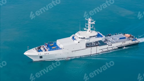 Preview: Aerial view of a modern patrol vessel sailing on calm turquoise sea,
