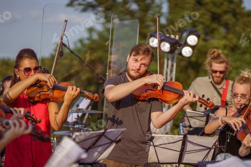 Preview: Violin players playing classic music at outdoor concert