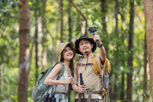 Preview: A travel blogger couple explores the forest, capturing stunning moments with their camera.