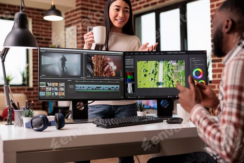 Preview: Diverse freelancers editing film footage on computer