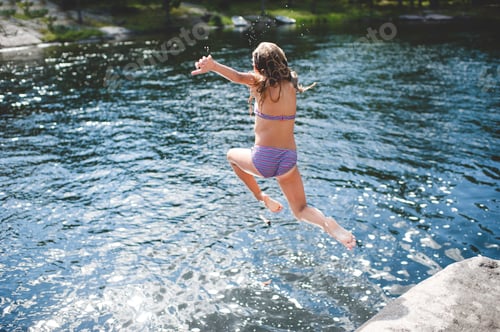 Preview: Girl in bikini jumping into water, Kings Lake, Ontario, Canada