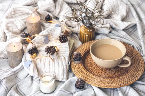 Preview: Cozy autumn composition with a big cup of coffee in bed.