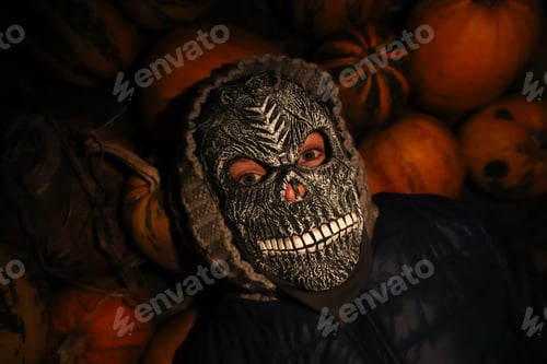 Preview: Defocus Halloween people. Person in grim reaper mask standing on