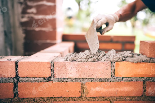 Preview: industrial Construction bricklayer worker building walls with bricks, mortar and putty knife