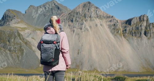 Preview: Rear view of woman discover Stokksnes looking at Vestrahorn mountain in the background Nature and