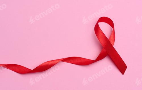 Preview: A silk red ribbon in the form of a bow on a pink background, a symbol of the fight against AIDS