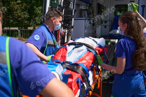 Preview: Ambulance team transports the patient on special stretcher to ambulance