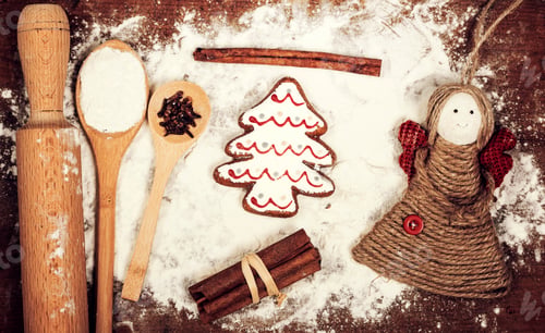 Preview: Gingerbread cookies, spices and flour over wooden cutting board