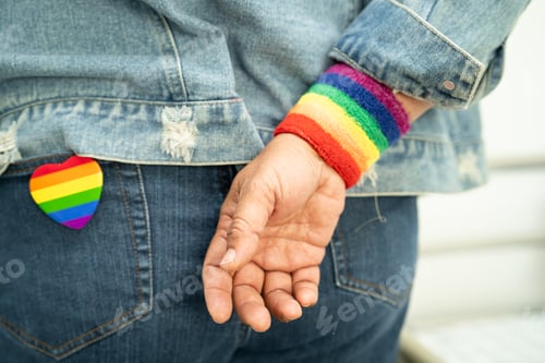 Preview: Person Wearing Rainbow Wristband and Heart Pin