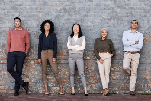 Preview: Portrait, collaboration and goals with a business team standing together, leaning on a brick wall.