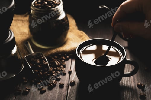Preview: hot coffee in a black mug with drip coffee maker on a wood floor