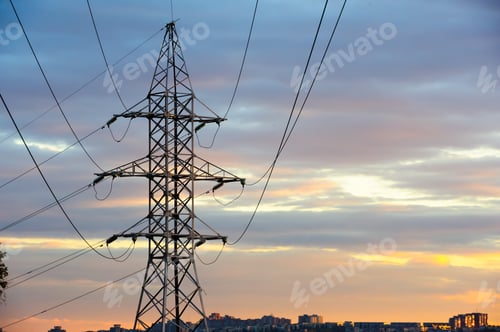 Preview: Electricity pylons and power lines silhouettes at a cloudy sunset.