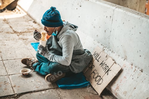 Preview: The beggars sat wrapped in cloths and eating noodles.