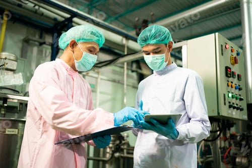 Preview: worker working in drink factory at conveyor belt with fruit juice glass bottled in production line