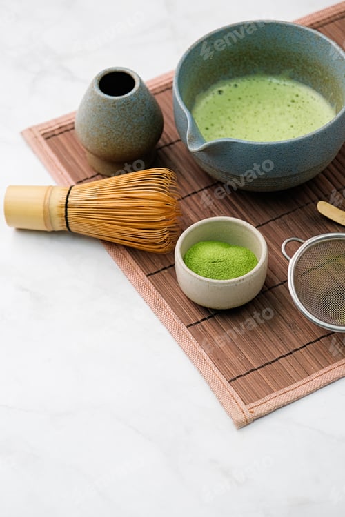 Preview: Traditional matcha kit, Bamboo whisk and beverage on bamboo mat in the kitchen