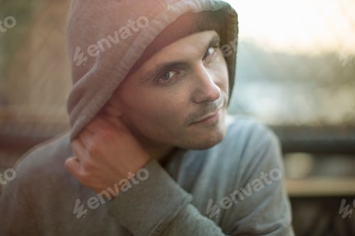 Preview: Man in contemplation as sunlight filters through
