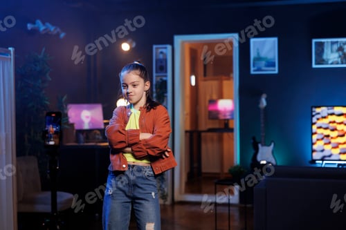 Preview: Kid uses cellphone on tripod stabilizer to record dance tutorial in studio for her online followers