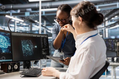 Preview: Cheerful data center admins doing fist bump, celebrating AI implementation