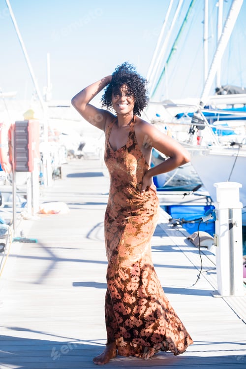 Preview: Portrait of black young woman in elegant dress in tourist outdoor leisure activity. Ethnic beauiful