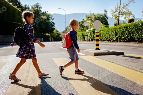 Preview: Kids with backpacks cross the road at crosswalk on the way to school. Child safety, education