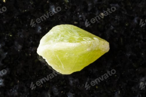 Preview: sample of raw sphene crystal on black granite