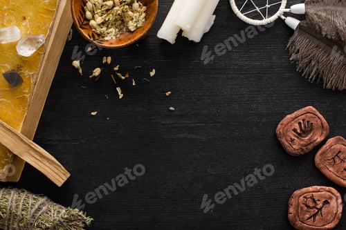Preview: Top View of Clay Amulets, Book With Dreamcatcher And Crystals on Black Wooden Background