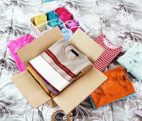 Preview: T-shirts and delivery box on the bed