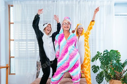 Preview: Beautiful senior women having funny pajama party at home
