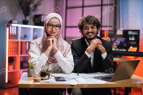 Preview: Confident two multi ethnic economists, young experienced muslim female and businessman