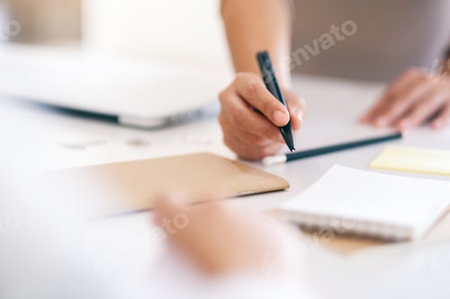 Preview: Group of businessman discussing and writing on notebook on the table in office