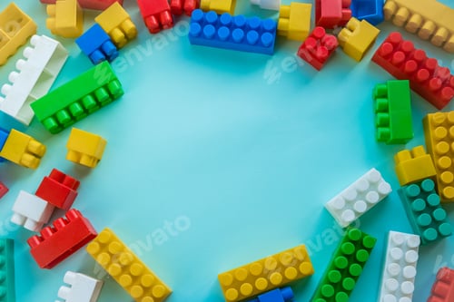 Preview: Close up Children plastic constructor. on a blue background stripe background. Developing toys