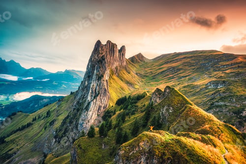 Preview: Sunset over majestic rocky mountain ridge of Saxer Lucke, Swiss Alps in autumn at Switzerland