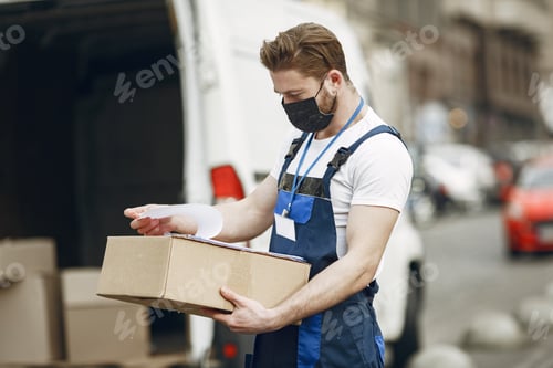 Delivery Man with Box and Clipboard in City