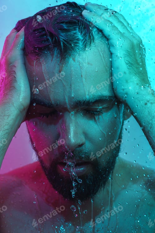 Preview: Portrait of handsome man under water flow in neon light