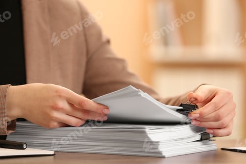 Preview: Woman working with documents at table in office, closeup