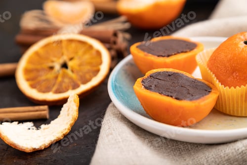 Preview: Truffle chocolate tangerine candies on a black concrete background. Side view, selective focus.