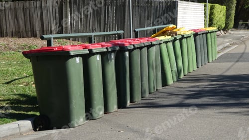 Preview: plastic garbage bins in a row out on the street ready for collection