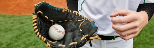 Preview: Dynamic teenager preparing to pitch on a sunny baseball field during a youth game