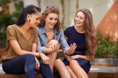 Preview: A group of young women sitting outdoors admiring a friends nails