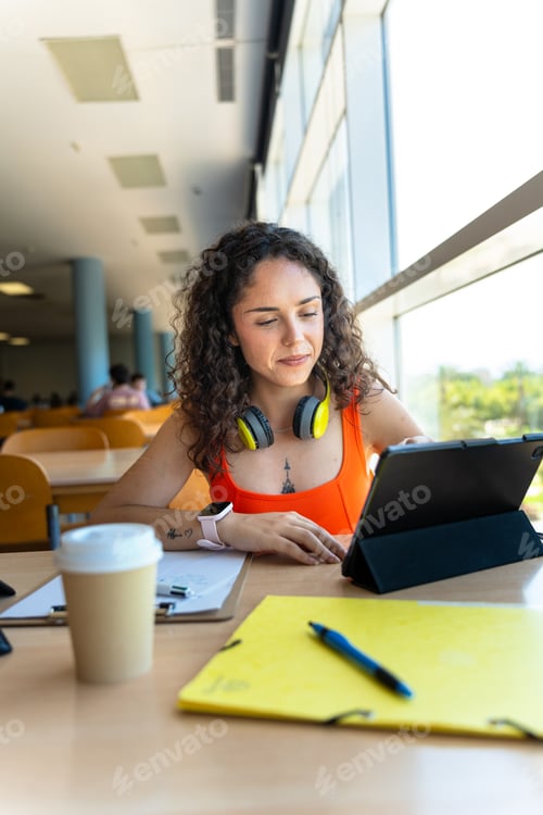 Preview: Modern learning: student using tablet in library