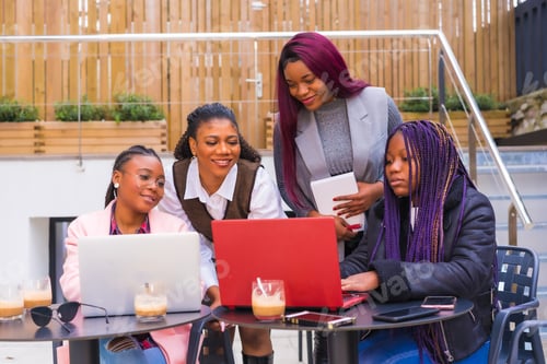 Preview: Young businesswomen of black ethnicity. In a business meeting in a cafeteria