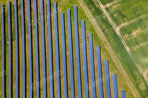 Preview: Aerial view of big sustainable electric power plant with many rows of solar photovoltaic panels