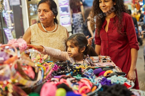 Preview: Family shopping for accessories at a vibrant street market