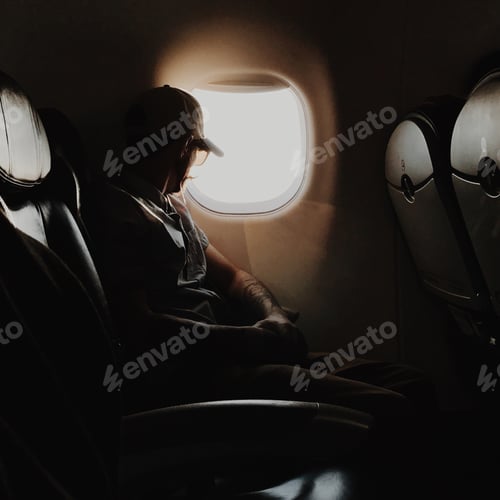 Preview: Contemplative Adult Looking Out Airplane Window