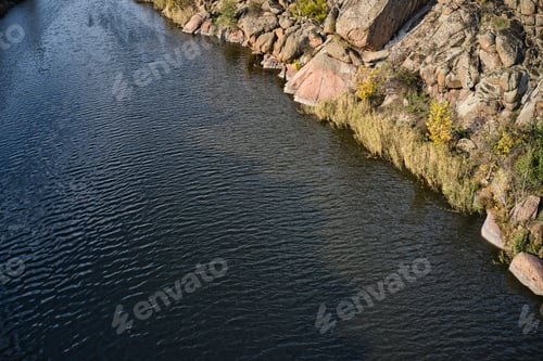 Preview: A smooth shining stream flows among large boulders